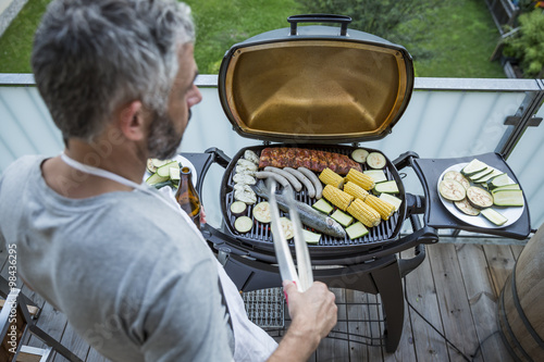 Man barbecuing on his balcony