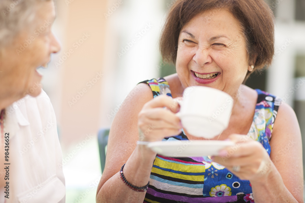 Two happy senior women drinking coffee together Two happy senior women drinking coffee together