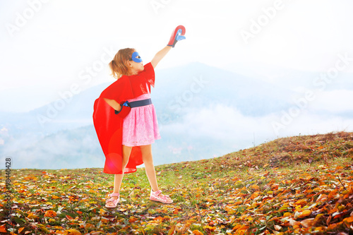 Superhero little girl poses...