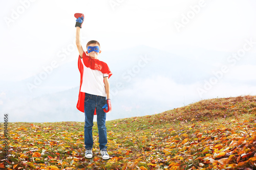 Boy dressed as superhero wi...