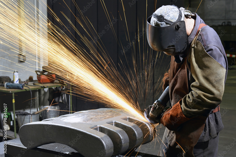Working with grinding machine in a foundry Working with grinding machine in a foundry