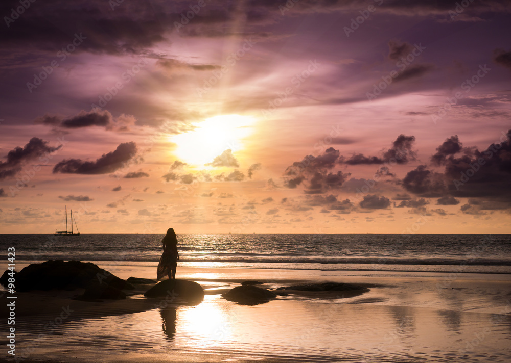 Young woman looking sunset on the beach in Phuket Thailand