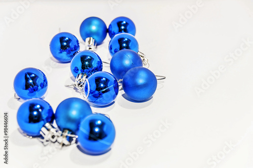 Lot of blue small decorative christmas balls on white