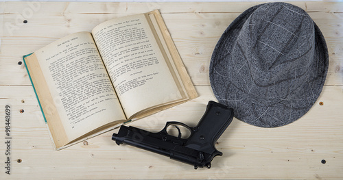 Stillife composition with hat and gun on wood table photo