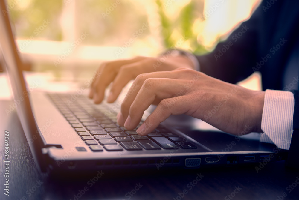 Man's hands typing on laptop keyboard Man's hands typing on laptop keyboard