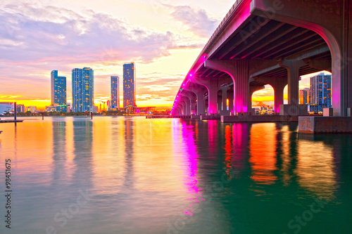 Miami Florida at sunset, colorful skyline of illuminated buildings and Macarthur causeway bridge © FotoMak