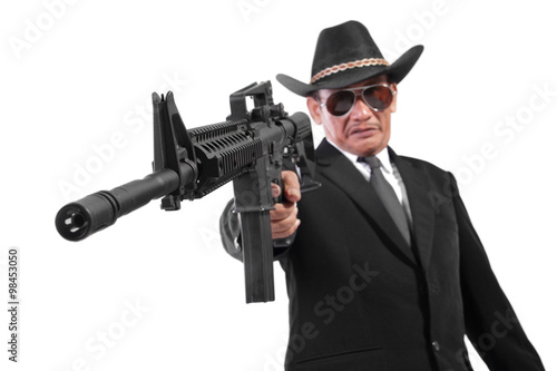Evil gangster and his gun  isolated on white