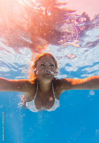 Young woman swimming underwater