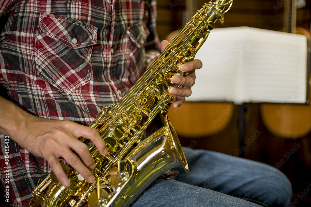 Fototapeta premium Close up of a man playing Alto Saxophone