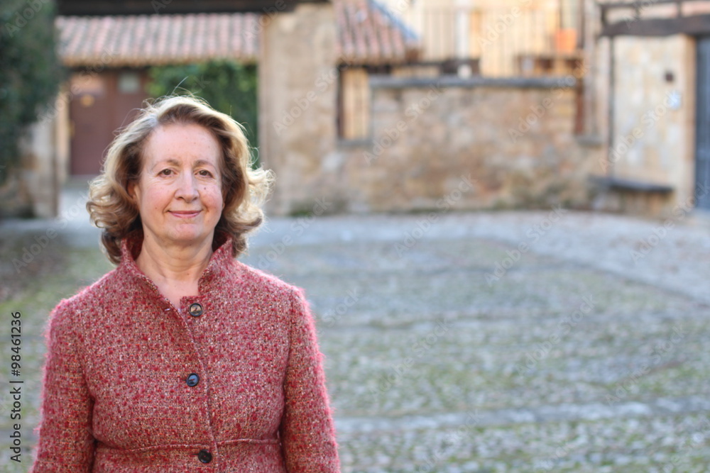 Smiling woman in her 60s outdoors Smiling woman in her 60s outdoors