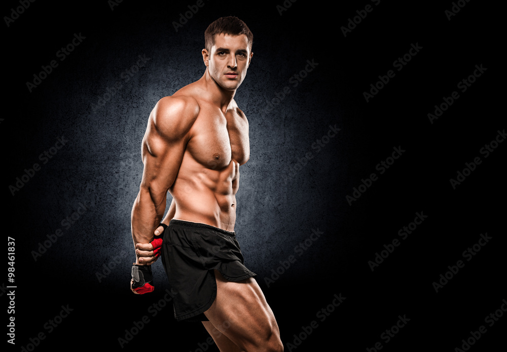 Fototapeta premium a young and fit male model posing his muscles