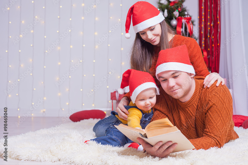 Happy family reading a book with christmas fairy tale Happy family reading a book with christmas fairy tale