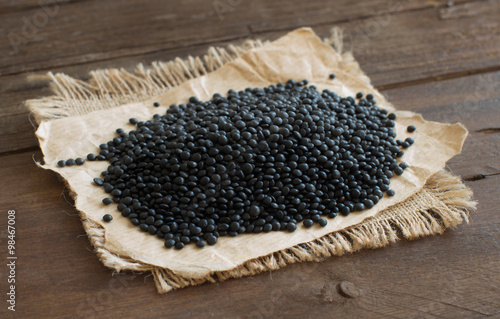 Pile of Black Lentils on wood