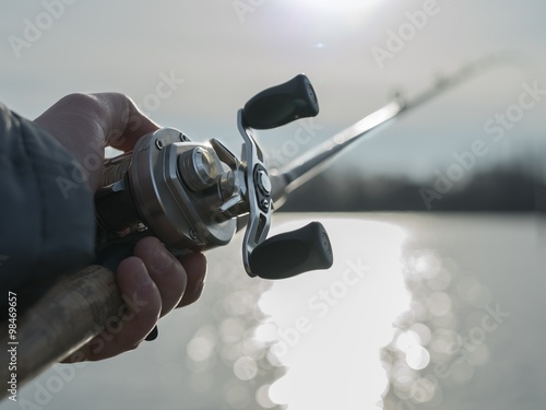 Angler with baitcasting reel in hilights photo