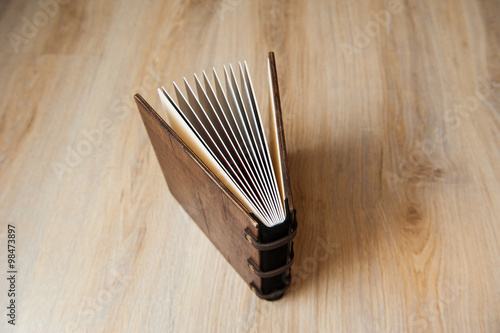 photo book in a brown wooden cover