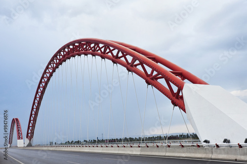 Modern bridge with characteristic red arches photo