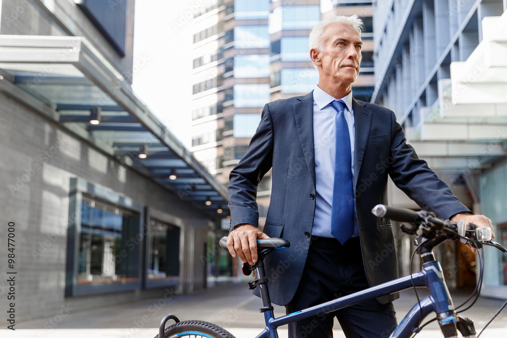 Successful businessman riding bicycle