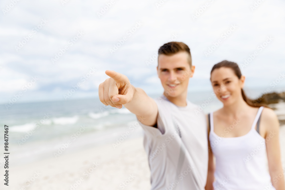 Couple of runners standing together on beach Couple of runners standing together on beach