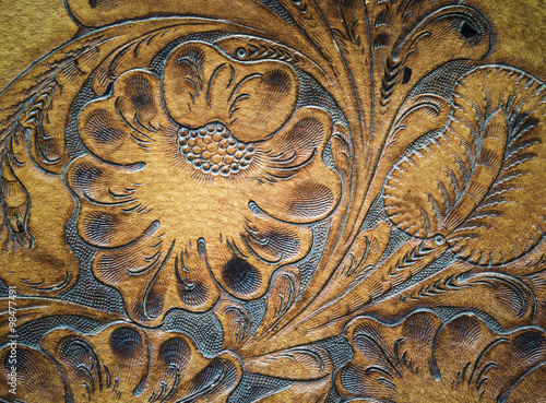 Brown leatherwork carved detail on saddle.