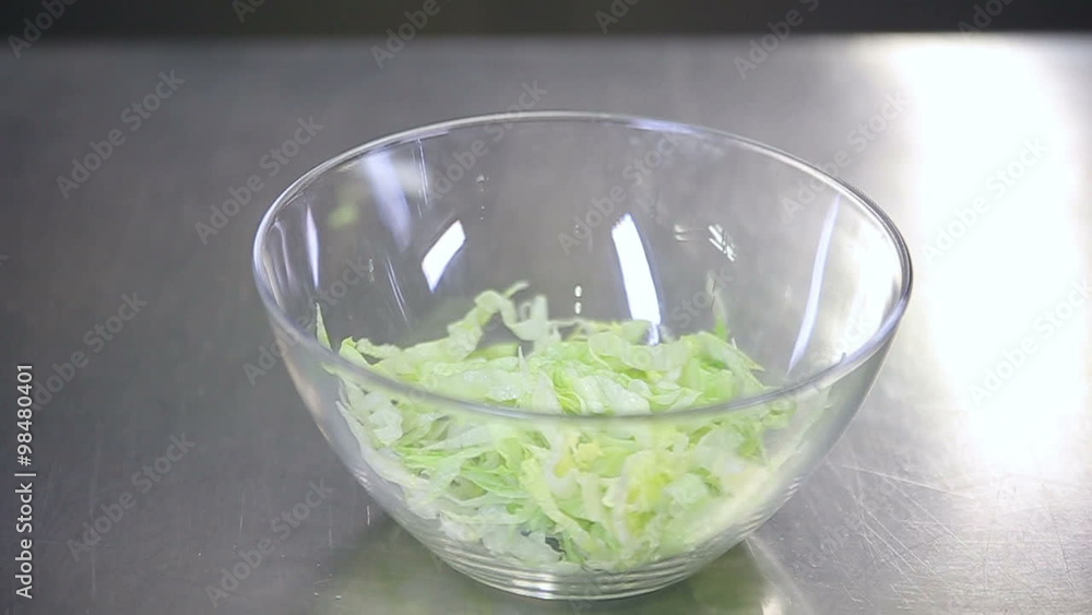 Cooking fresh vegan salad of iceberg, red pepper and fresh vegetables Cooking fresh vegan salad of iceberg, red pepper and fresh vegetables