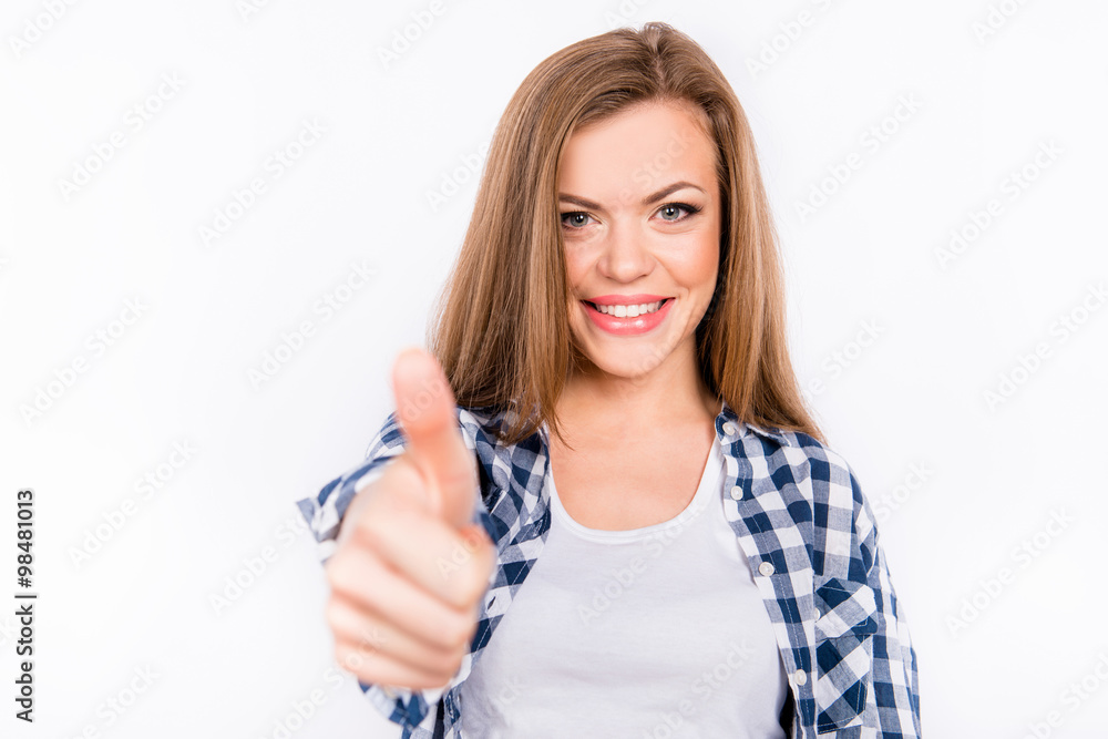 Happy smiling girl shows thumb up by one hand Happy smiling girl shows thumb up by one hand