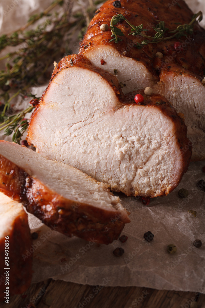 Delicious sliced roasted turkey close-up on paper. vertical
Delicious sliced roasted turkey close-up on paper. vertical