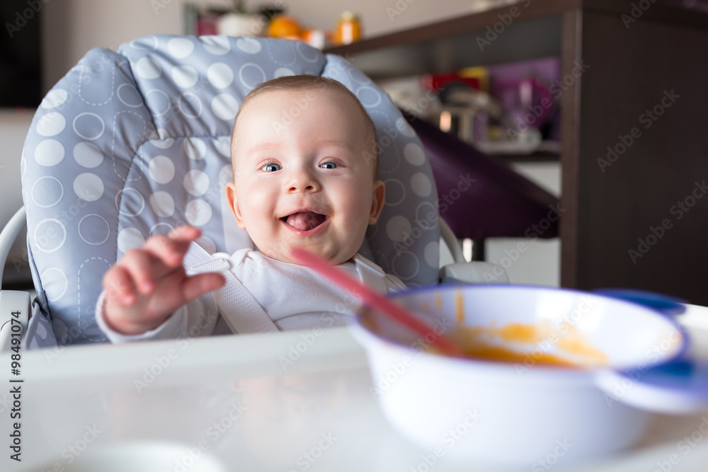 Baby boy sitting on the high chair for lunch Baby boy sitting on the high chair for lunch