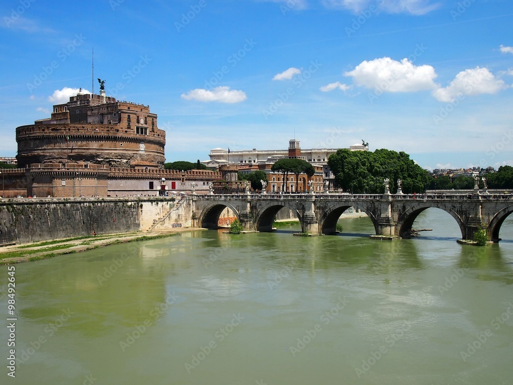 Castle St Angelo and Bridge of Angels along the Tiber river on a sunny summer day in Rome