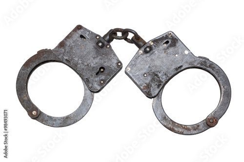 Old rusty handcuffs on white