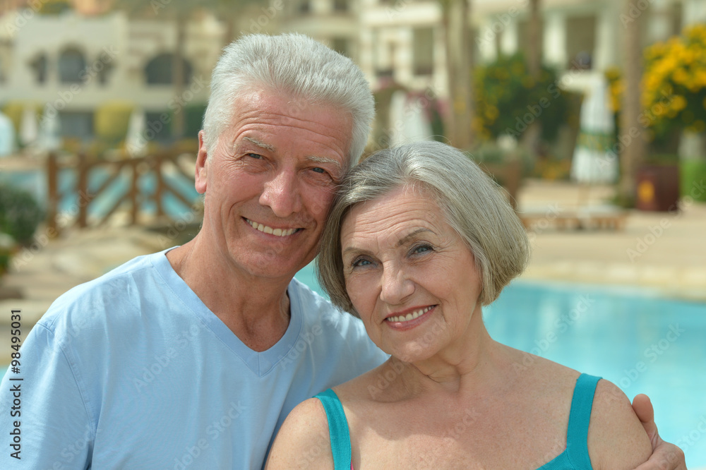 Senior couple relaxing at pool