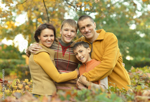 Family relaxing in autumn park