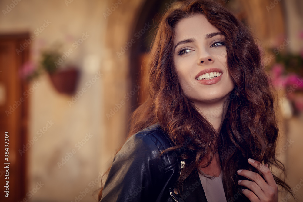 Fototapeta premium Fashionably dressed woman on the streets of a small Italian town