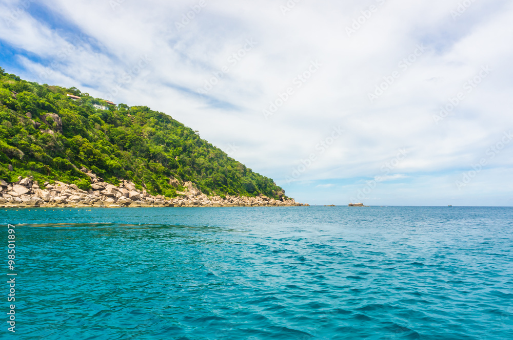 Naklejka premium Rocky island with Turquoise Water and Green Palm Trees