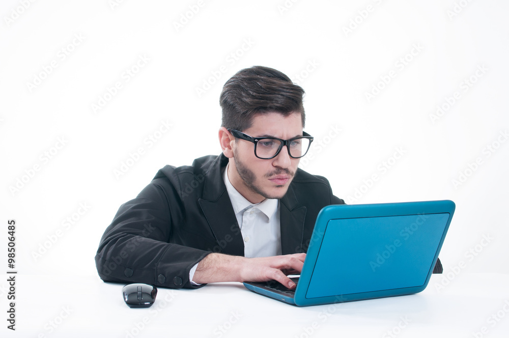 Young business man looking at his laptop with disappointment Young business man looking at his laptop with disappointment
