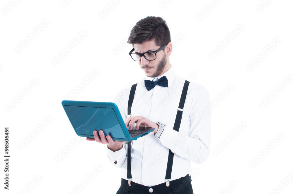 Young business man looking at his laptop with disappointment Young business man looking at his laptop with disappointment