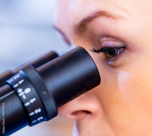 Scientist using a microscope in a laboratory