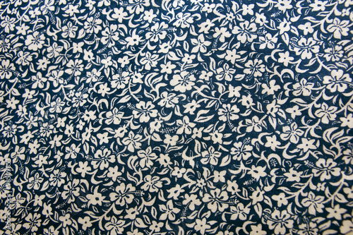 Closeup of blue cotton fabric with flowers.
