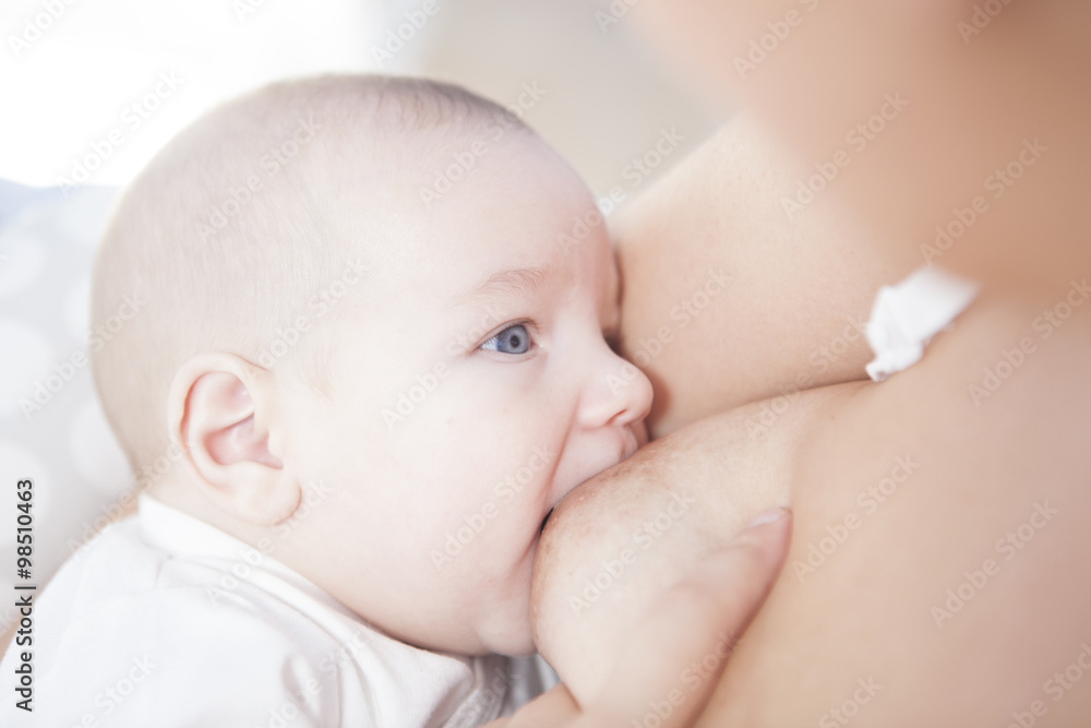 Young mother breastfeeding her little baby Young mother breastfeeding her little baby