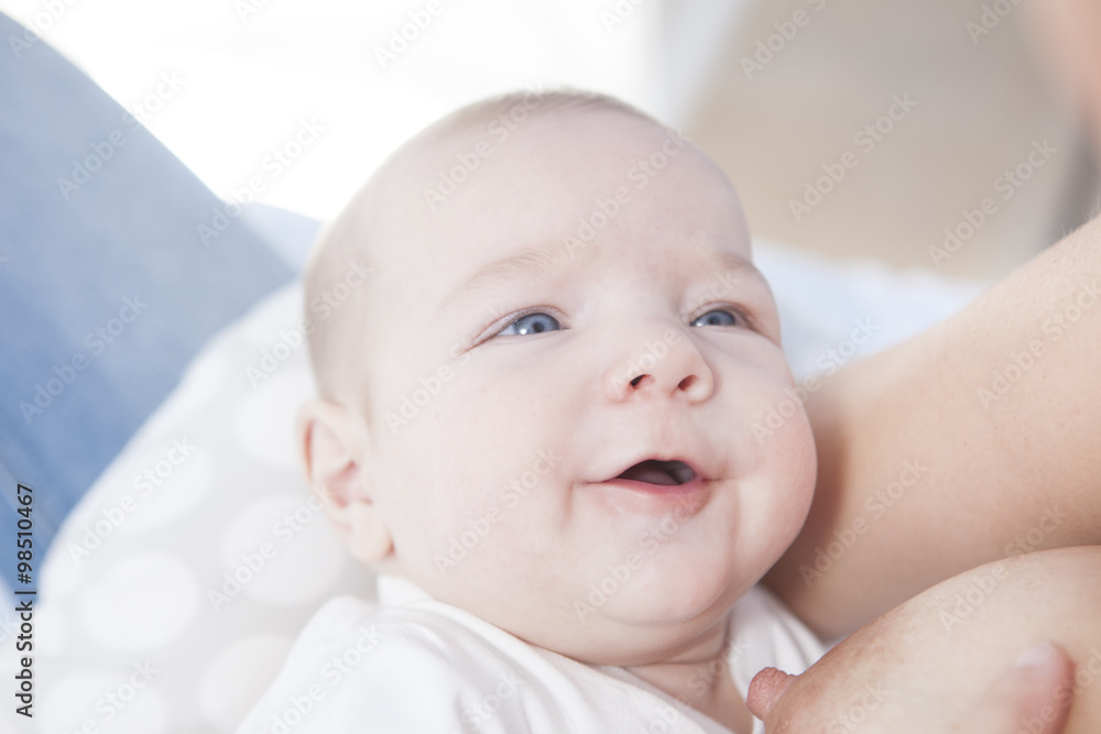 Smiling baby while he is breastfed Smiling baby while he is breastfed