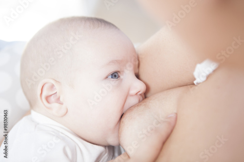 Young mother breastfeeding her little baby