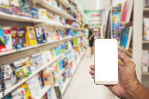 Smartphone white screen in hand on blurred book store