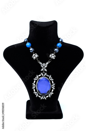 Pendant with big blue stone on a mannequin isolated on white
