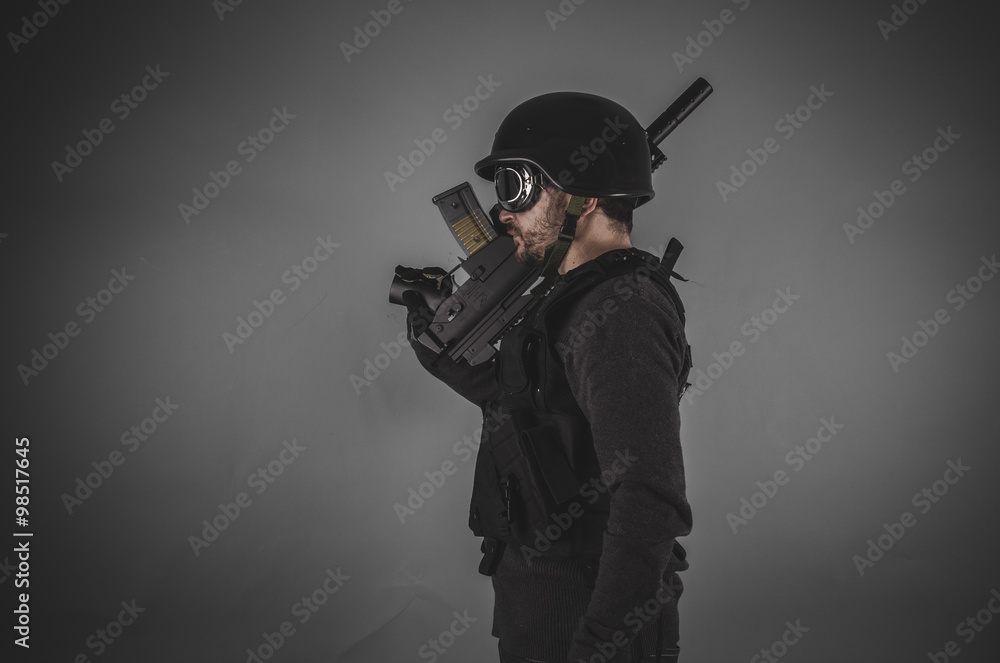 guard, airsoft player with gun, helmet and bulletproof vest on g