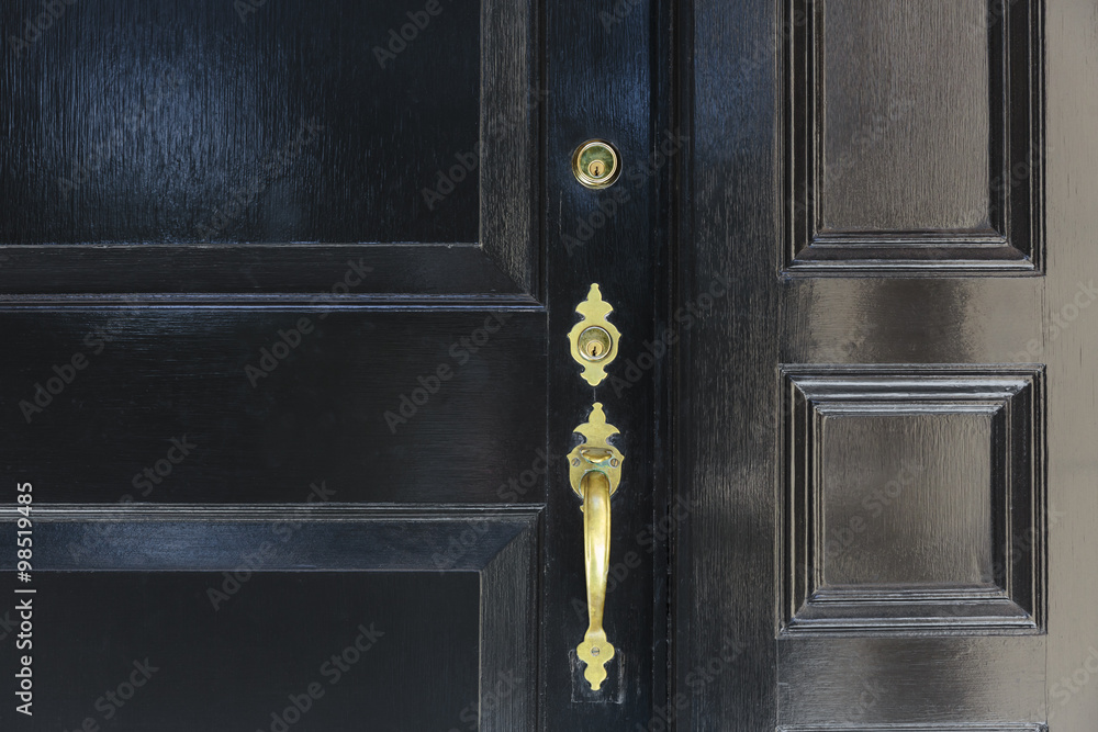 Fototapeta premium front door, close up of black front door with brass handle