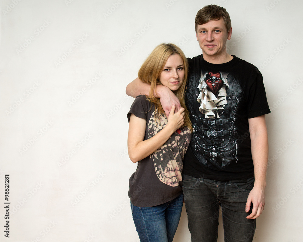 Yong couple against the white wall Yong couple against the white wall