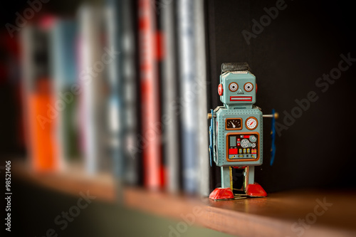 Vintage tin toy robot on a book shelf