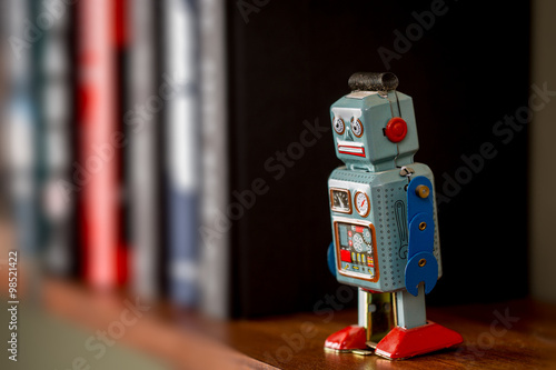 Vintage tin toy robot on a book shelf