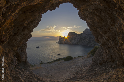 Sun setting behind the coastal cliffs. Crimea.