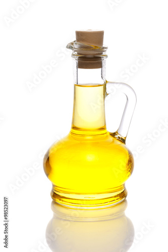 Olive oil in a bottle on white 