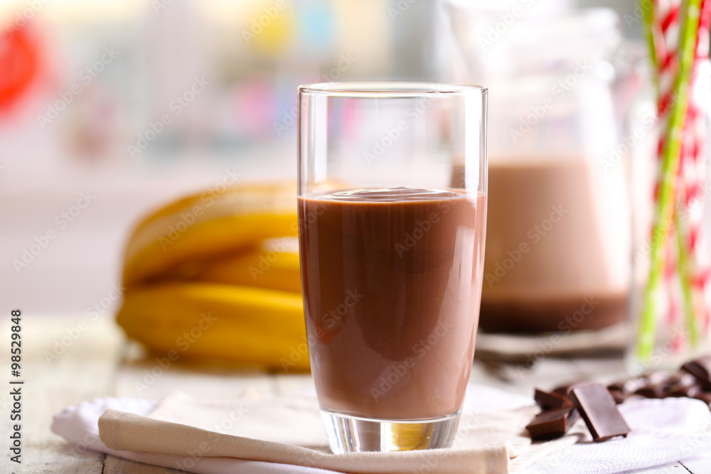 Glass of chocolate milk on table close-up Glass of chocolate milk on table close-up